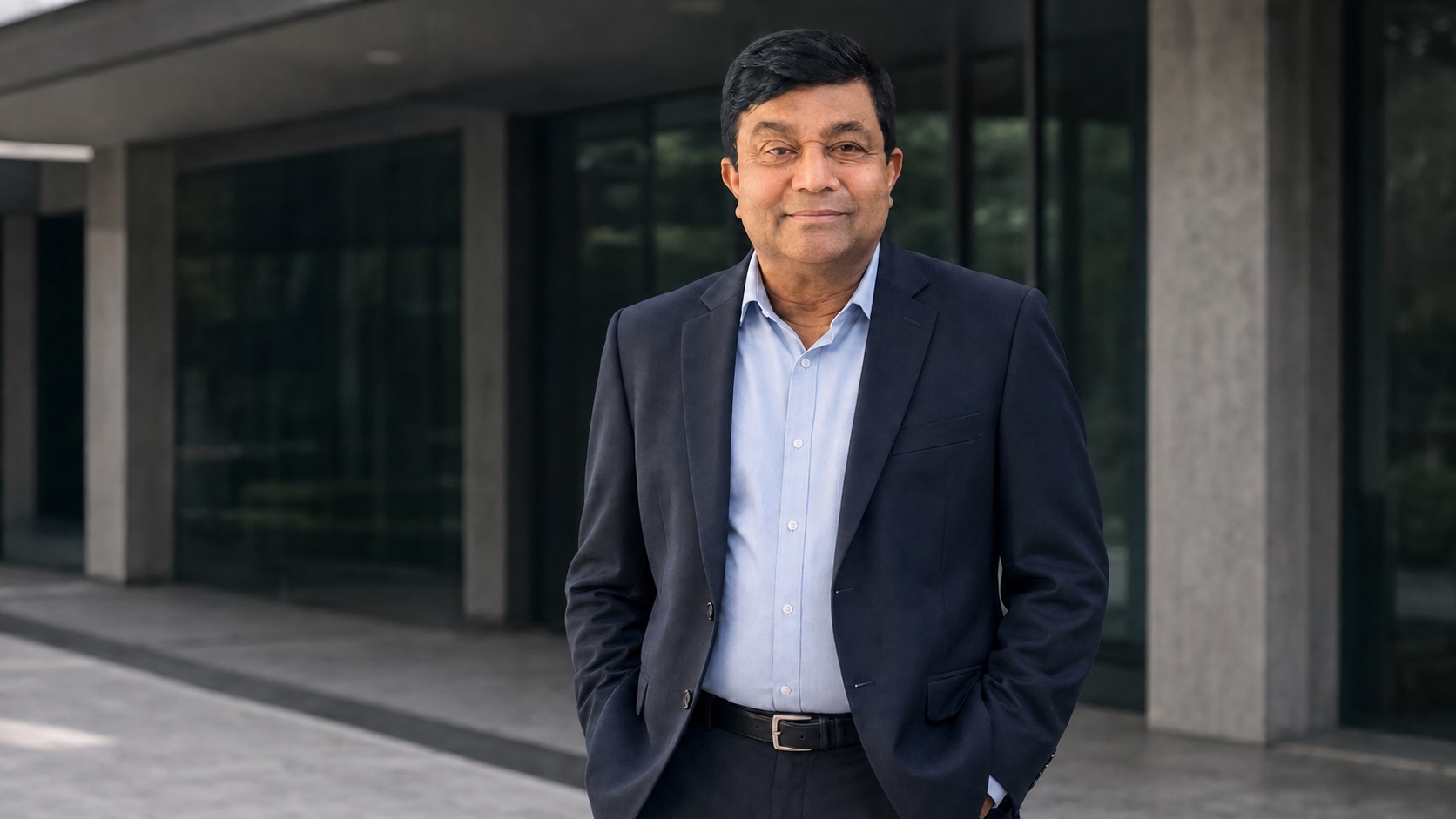 Prof. M. Thilakasiri standing outside a contemporary public institution